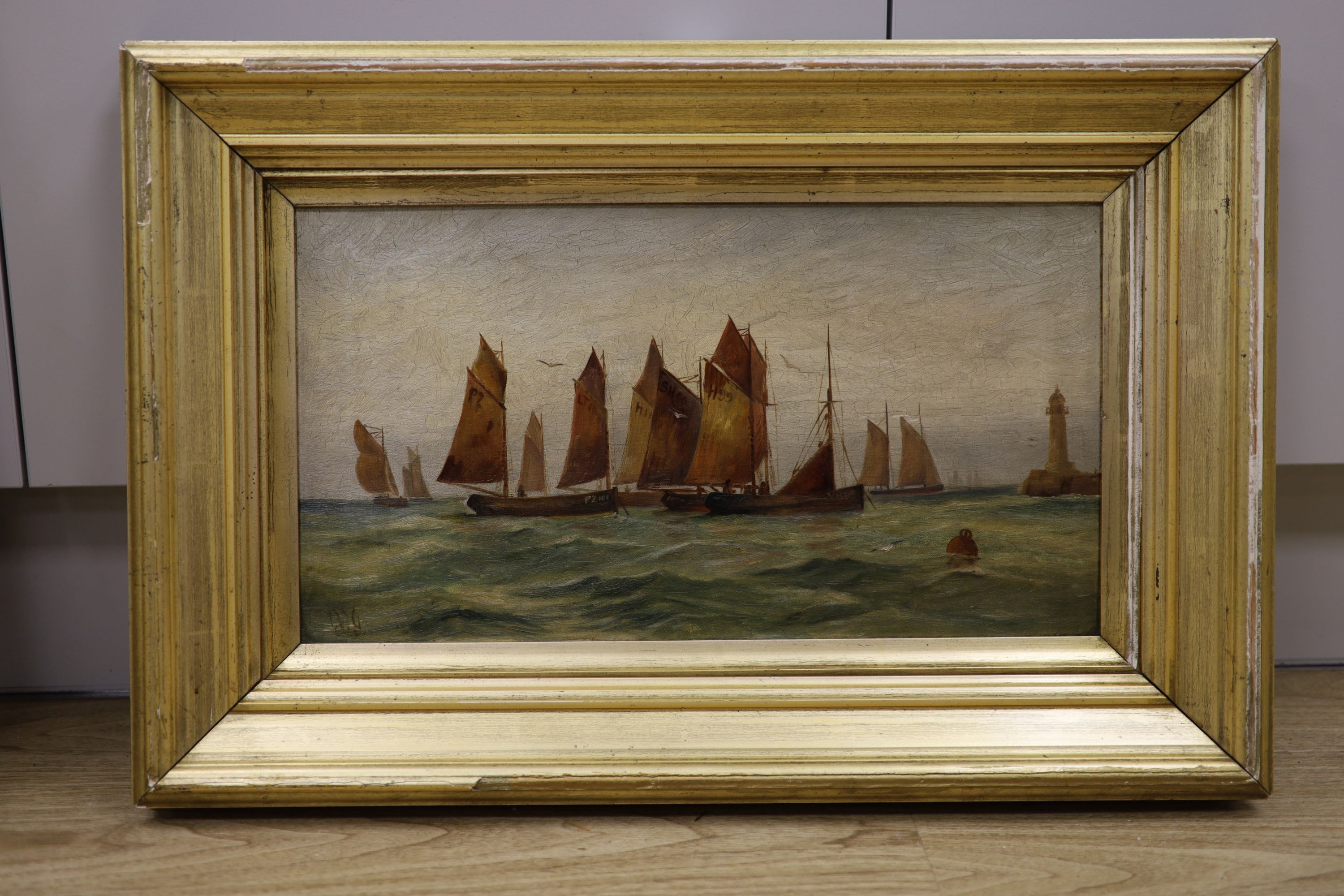 J.W.G. c.1990, oil on canvas, Cornish fishing boats off the coast, initialled, 25 x 45cm